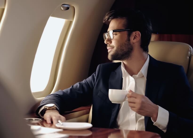 Smiling,Businessman,Holding,Cup,And,Looking,At,Window,In,Private
