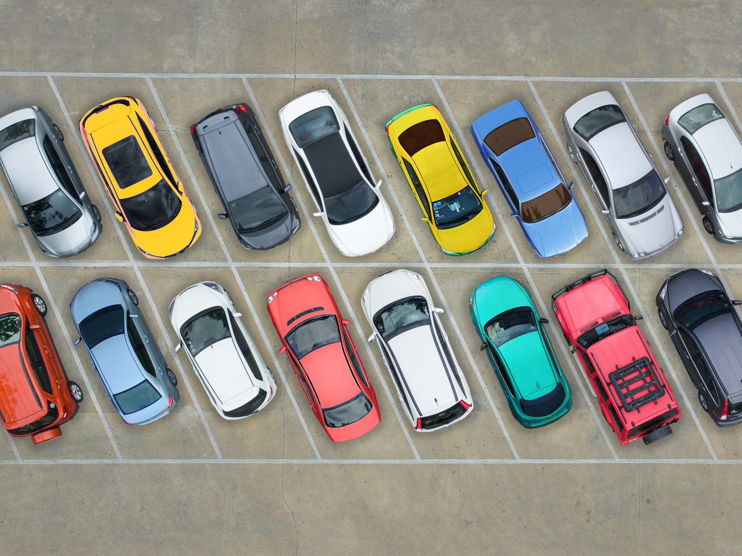 Arial view of multicolored cars in a parking lot